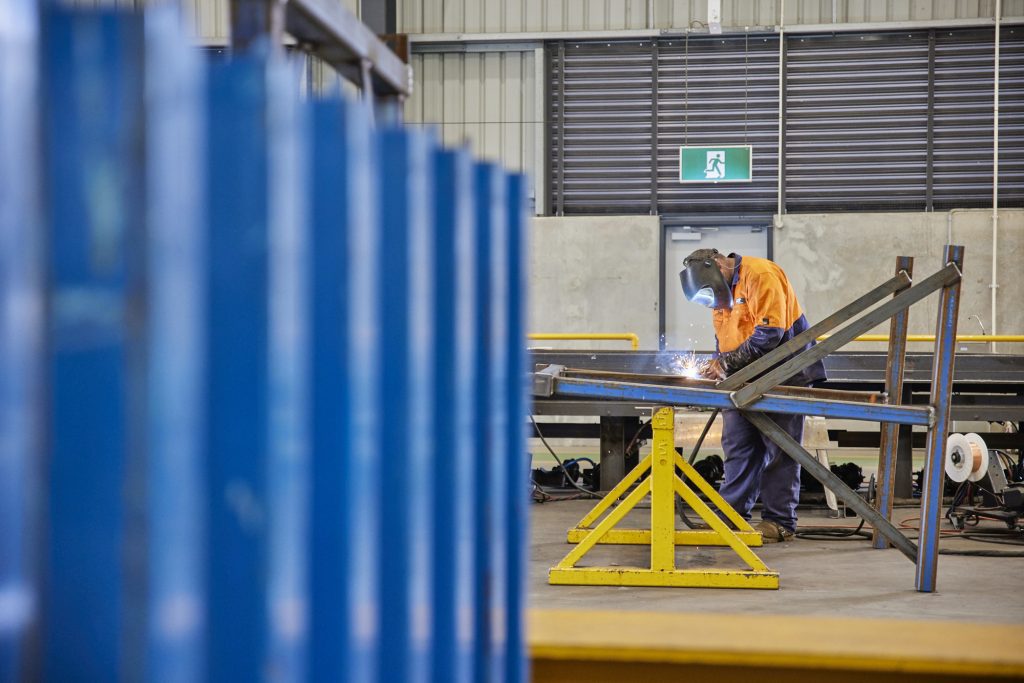 Man at GLT Trailers working on a repair job through NTI Insurance